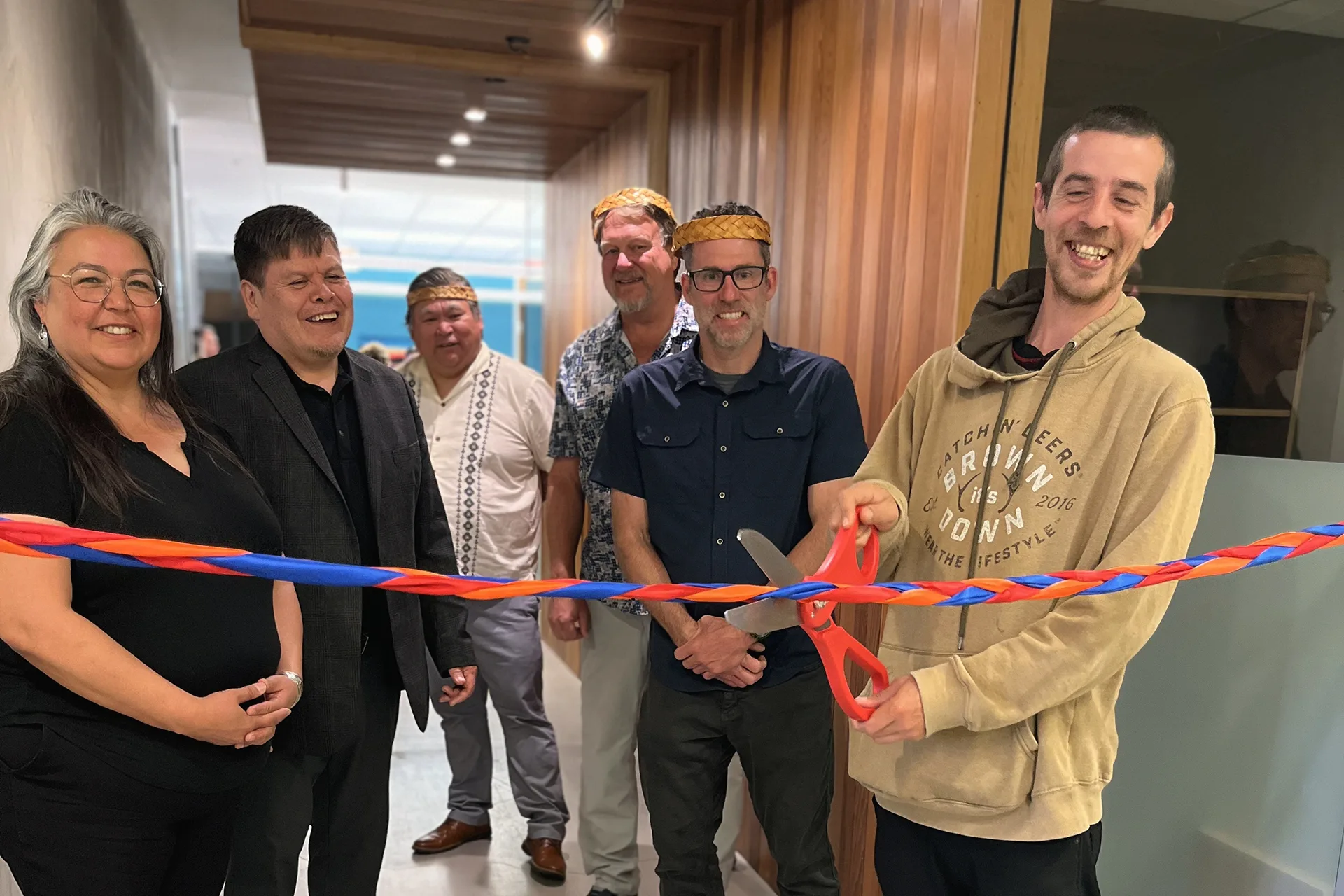 Legislative Chief Benjamin Gillette, Ka:’yu:’k’t’h’ / Che:kles7et’h’ First Nations, cuts the ribbon at the grand opening of the Tiičma Enterprises building acquisition.
